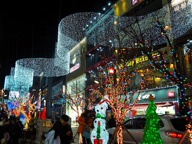 Gwangbok-ro street with Christmas lights including trees, snowmen and overhead banner, in Nampo, Busan, South Korea