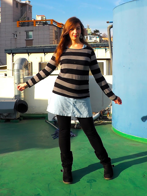 Sweater Weather | outfit of black and grey striped jumper worn over denim dress, with black legging and high boots