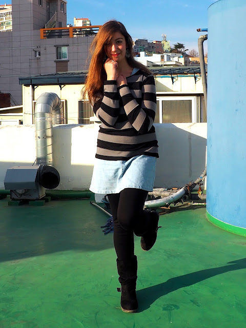 Sweater Weather | outfit of black and grey striped jumper worn over denim dress, with black legging and high boots