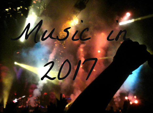 "Music in 2017" text on background of lights and crowd at rock concert