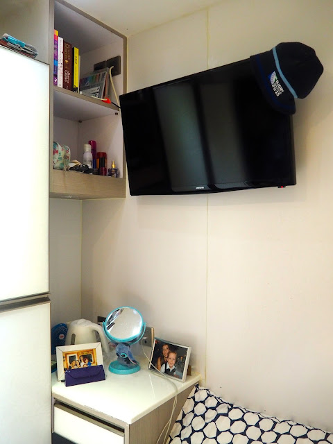 Table, shelves and TV in my studio apartment in Sham Shui Po, Kowloon, Hong Kong