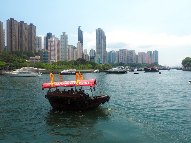 Sampan of tourists sailing through the harbour at Aberdeen, Hong Kong