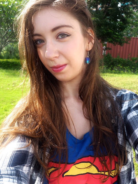 Girl of Steel | outfit details of blue stone dangly earrings with Supergirl top & checked shirt