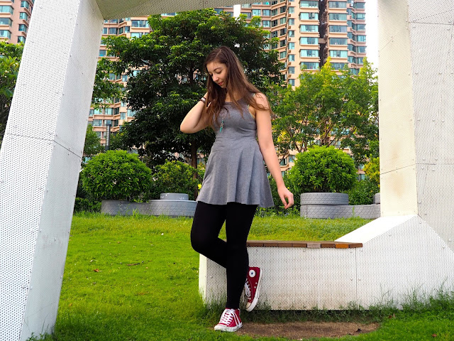 On The Move | outfit of short grey skater dress, black leggings, and red high top Converse