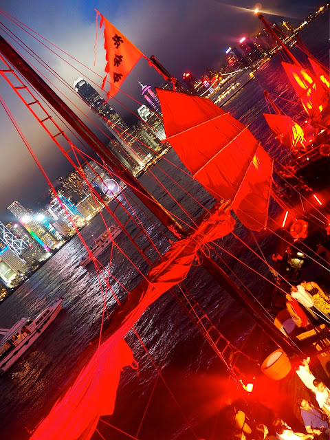 Junk boat and skyline at night in TST, Kowloon, Hong Kong