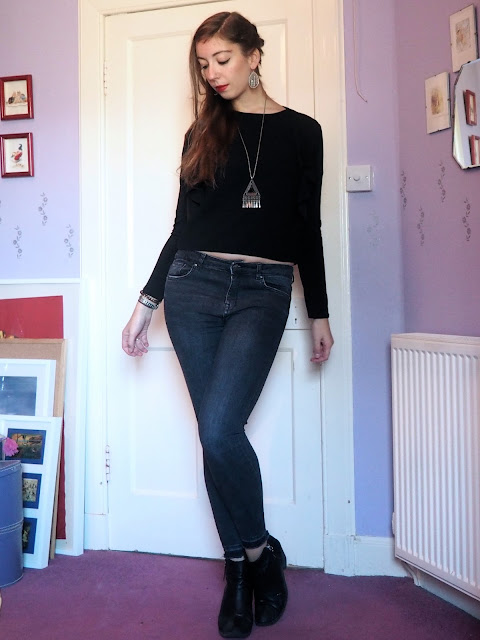 Back to Black | outfit of black shrug jacket & short top, grey skinny jeans & black heeled ankle boots