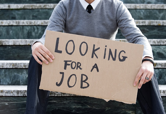 "Looking for a job" cardboard sign, from unemployed job hunter.