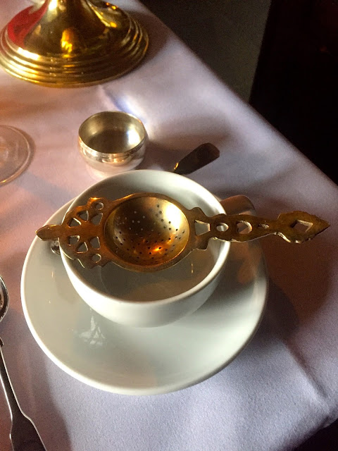 Tea cup and strainer for afternoon tea in The Witchery by the Castle, Edinburgh