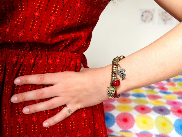 Arthur from The Sword in the Stone Disneybound - outfit details of red patterned dress with gold & red owl charm bracelet
