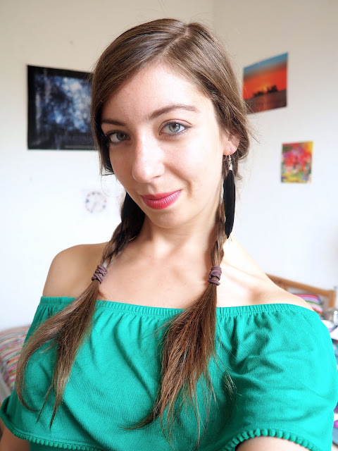 Peter Pan inspired Disneybound outfit details of black feather earrings, with hair braids and natural makeup