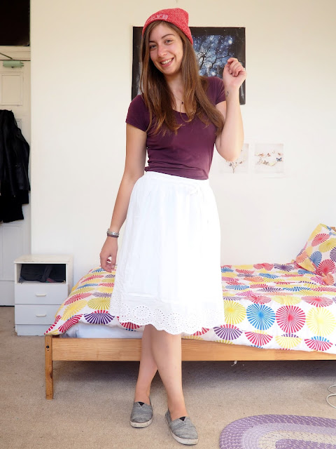 Aladdin inspired Disneybound outfit of dark purple top, long white skirt, grey Toms shoes and red beanie hat