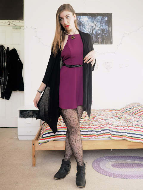 Evil Queen Disneybound villain outfit of bright purple dress, black cape cardigan, spider web tights and black ankle boots
