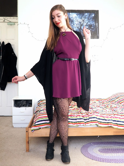 Evil Queen Disneybound villain outfit of bright purple dress, black cape cardigan, spider web tights and black ankle boots
