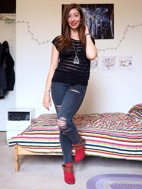 Ruby Red - outfit of black sheer striped top, grey ripped skinny jeans, and red high heeled ankle boots with brown straps