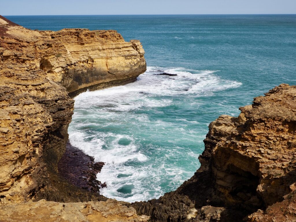 Great Ocean Road - second feature photo - rocky cliff face with a blue ocean inlet on the coast - near the Grotto, Victoria, Australia