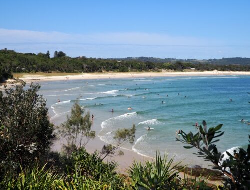 Sydney to Byron Bay - feature photo - surfers at The Pass in Byron Bay, NSW, Australia