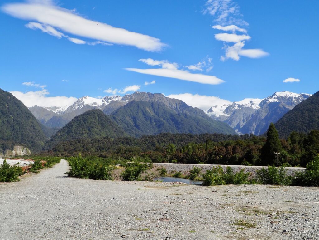 Highlights of the West Coast - second feature photo - view of the Southern Alps with snowy peaks from near Franz Josef town, New Zealand